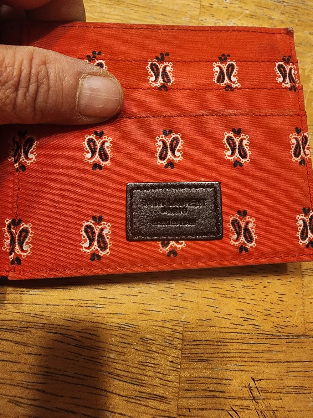 Saint Laurent wallet features a distinctive paisley bandana print on interior